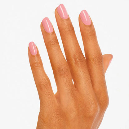 Hand with pink nail polish on a white background